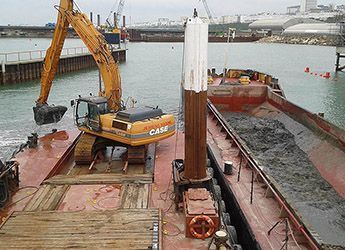 dredging ops with multicat and excavator alongside split hopper barge