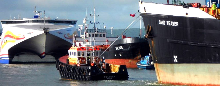 tugboat Polmear navigates a busy harbour