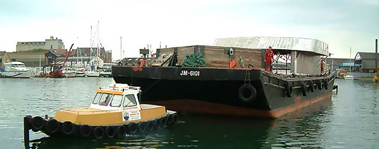 Beaver workboat towing Flat deck cargo barge