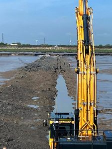 Outfall trench being excavated during low tide